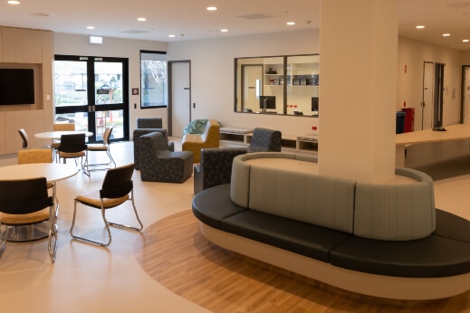 A room with chairs, screens and a door makes up one of the common areas at Canberra's Adult Mental Health Unit. 