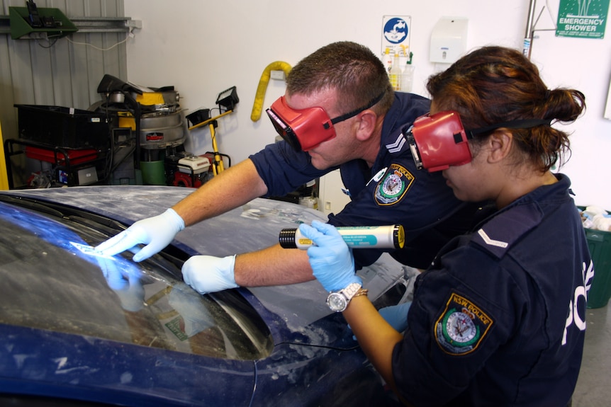 Police examine bullet hole in car windscreen