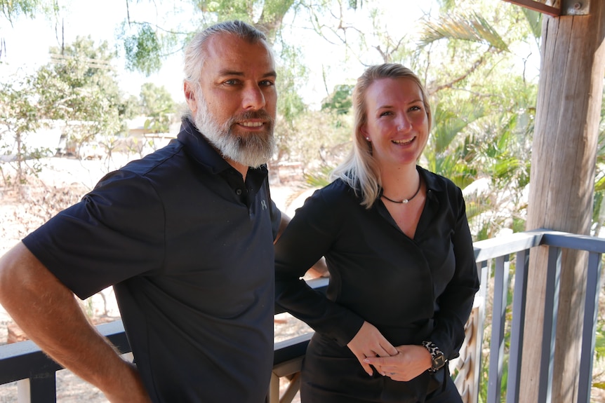 Paul Rider Boon and Jody Douglas stand on a balcony.