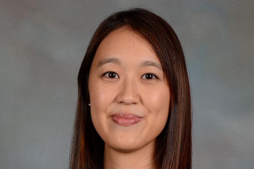 A young woman smiles at the camera as she poses for a headshot.