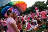 Participants dressed in pink enjoy a picnic