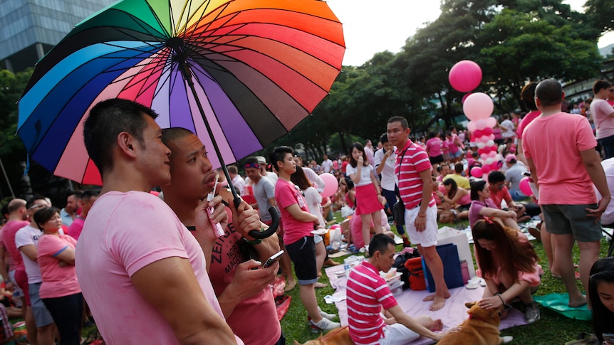 Participants dressed in pink enjoy a picnic