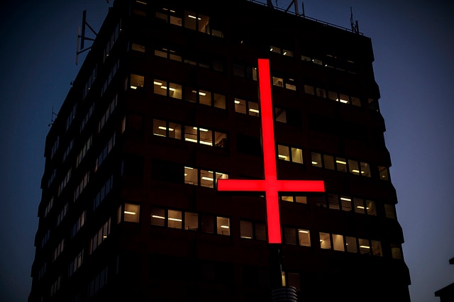 Picture of a red inverted cross outside a tall building