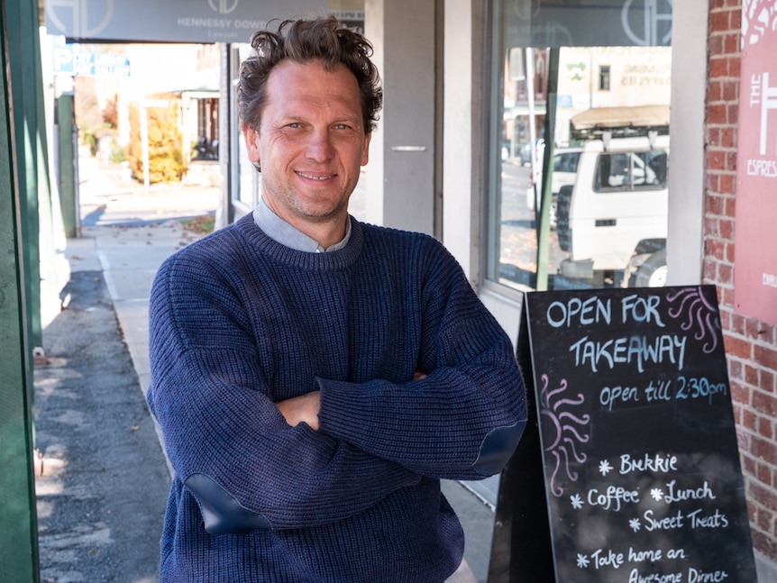 Bathurst Regional Council councillor Jess Jennings standing on footpath next to cafe sign.