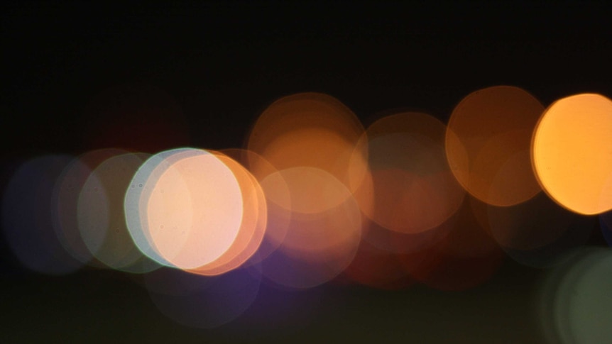 Blurred coloured lights against a black background