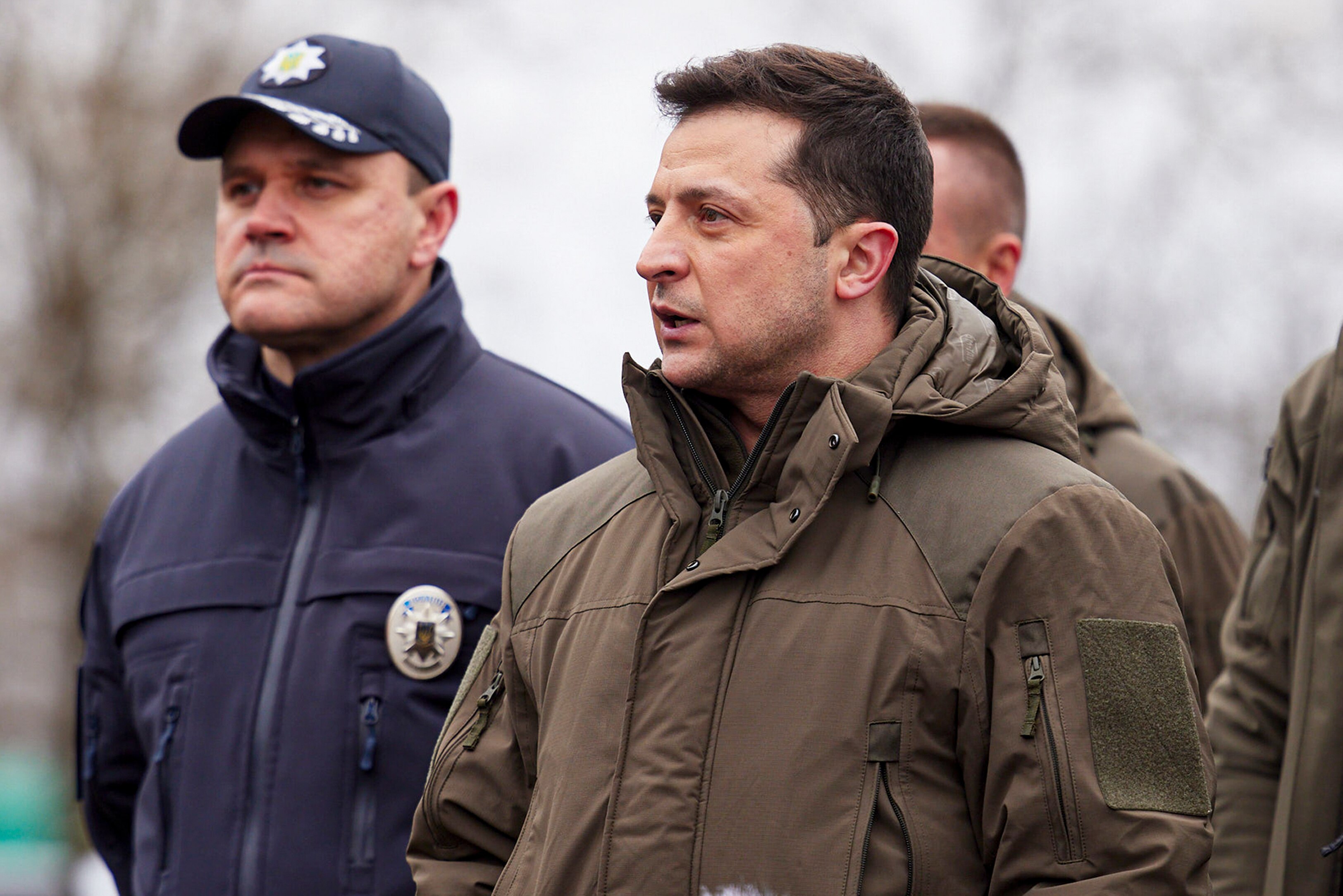 Volodymyr Zelenskyy standing outdoors.