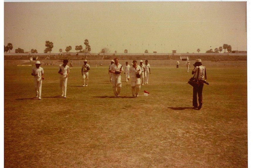 A shot of cricketers walking from the field.