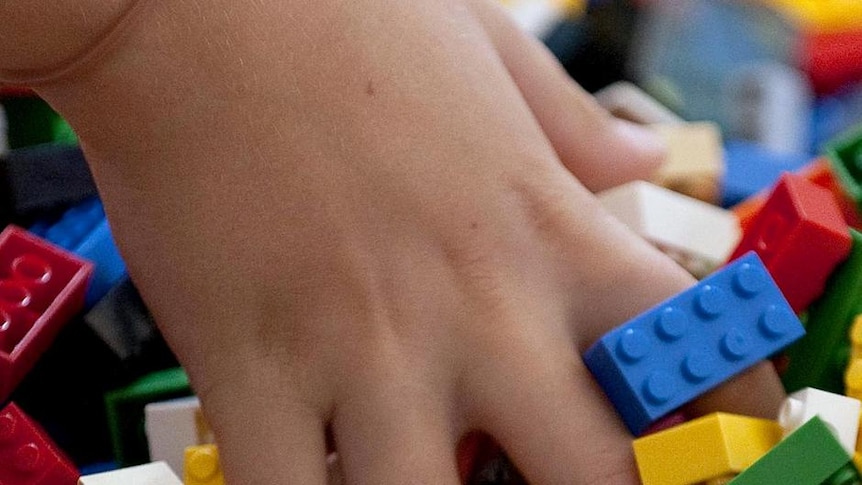 A child plays with Lego blocks