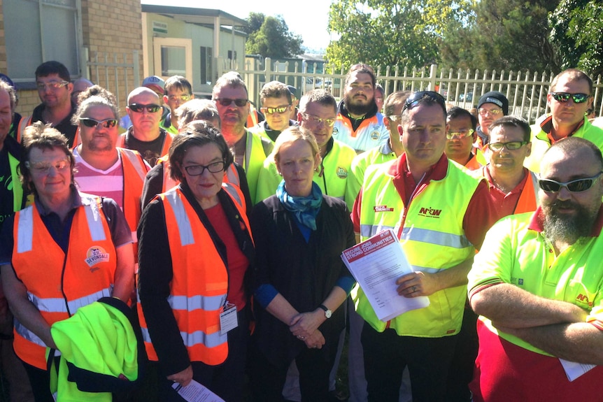 A group of dairy workers stand outside the Kiewa processing plant with local Independent MP Cathy McGowan