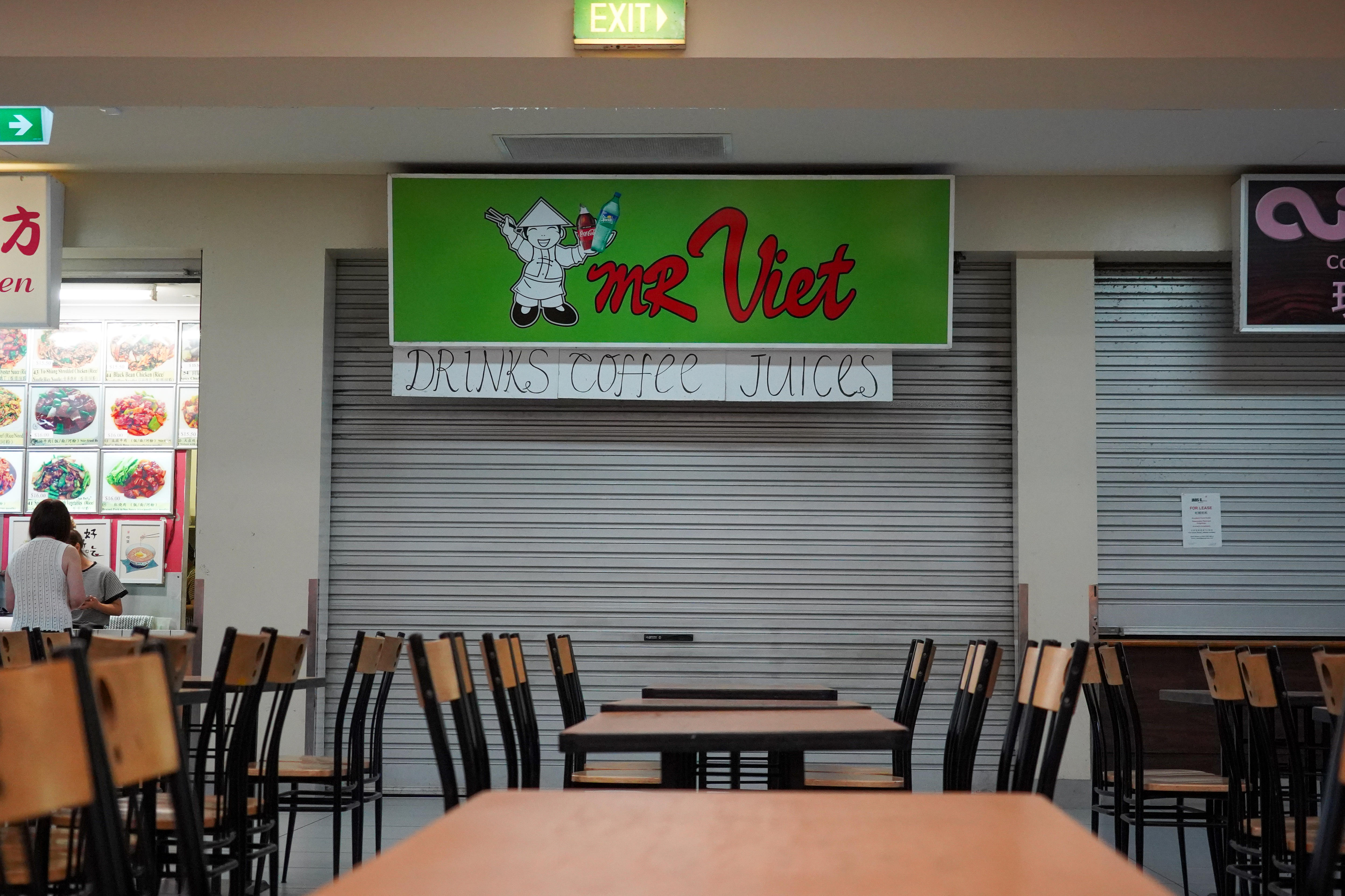 A closed restaurant in a food court.