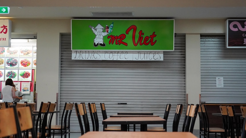 A closed restaurant in a food court.