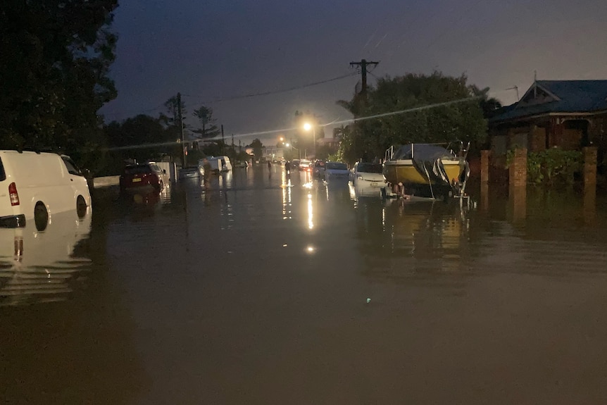 A heavily flooded suburban street,