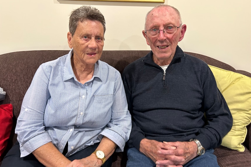 An older woman with short hair on the left and an elderly fellow wearing glasses on the right 