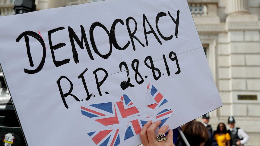 A white poster saying 'Democracy RIP 28.08.19'