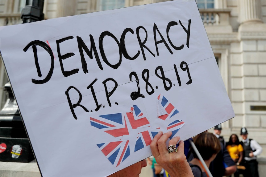 A white poster saying 'Democracy RIP 28.08.19'