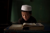 A boy reads the Quran at an Afghan madrassa, September 28, 2021.
