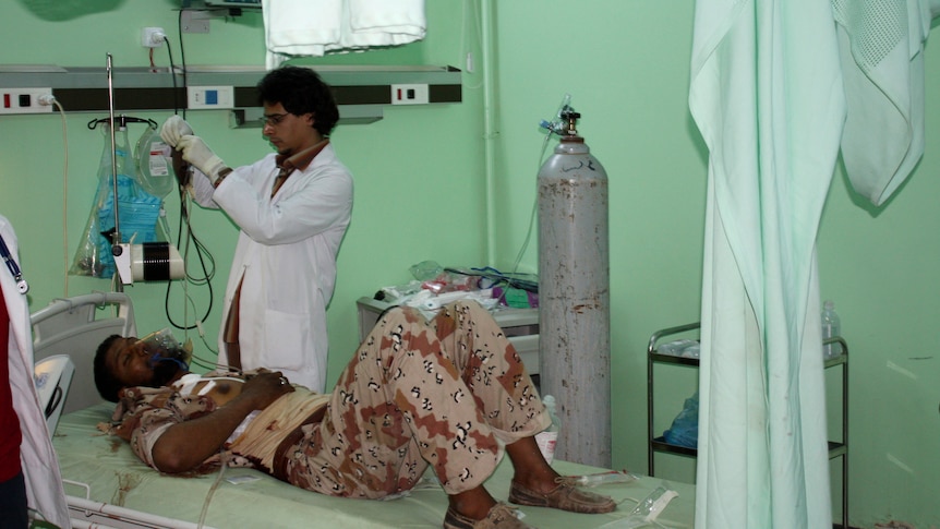 An injured fighter receives treatment