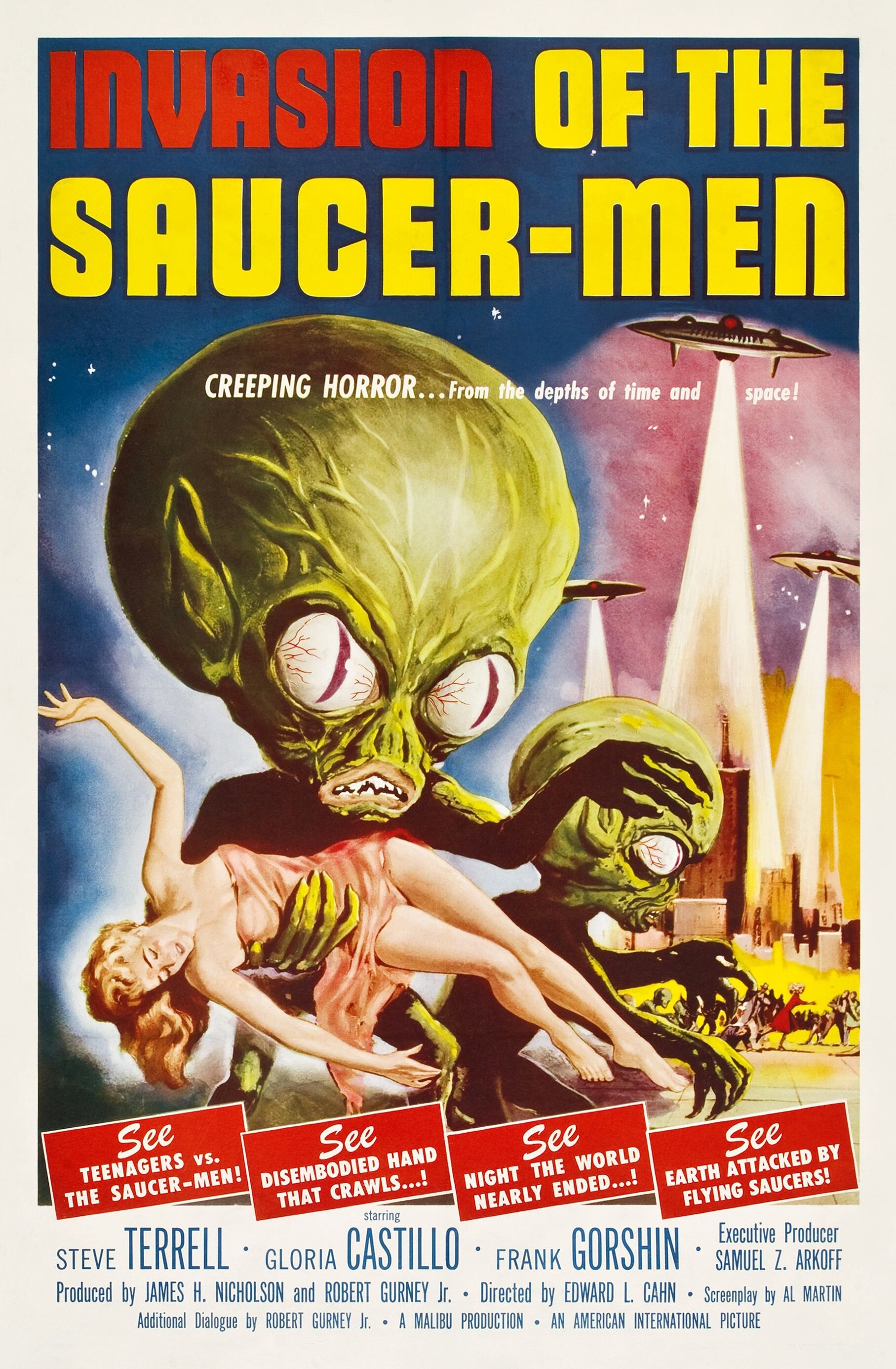 A 1950s film poster of 'Invasion of the Saucer-men' featuring aliens with large green heads grabbing a woman