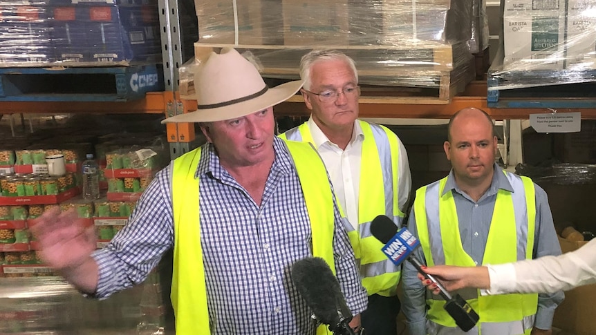 Three men at a press conference