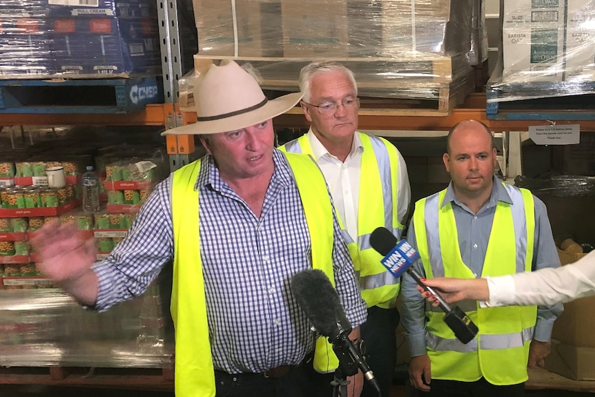 Three men at a press conference