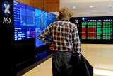 An elderly man watches the share market prices at the Australian Stock Exchange