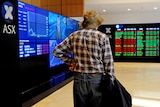 An elderly man watches the share market prices at the Australian Stock Exchange in Sydney
