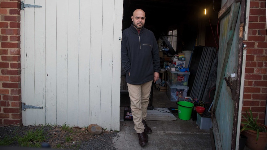 Luis standing at the entrance of a garage in Melbourne's northern suburbs.