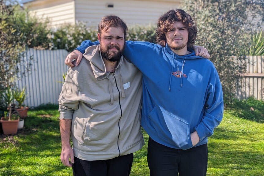 Jaymz Lester-Stevens wearing a cream hoodie, next to his brother Jack wearing a blue hoodie.