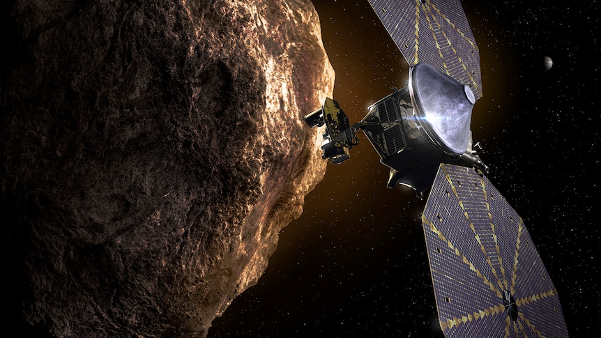 An artist's impression of the Lucy spacecraft flying by a Trojan asteroid.