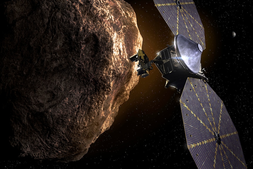 An artist's impression of the Lucy spacecraft flying by a Trojan asteroid.