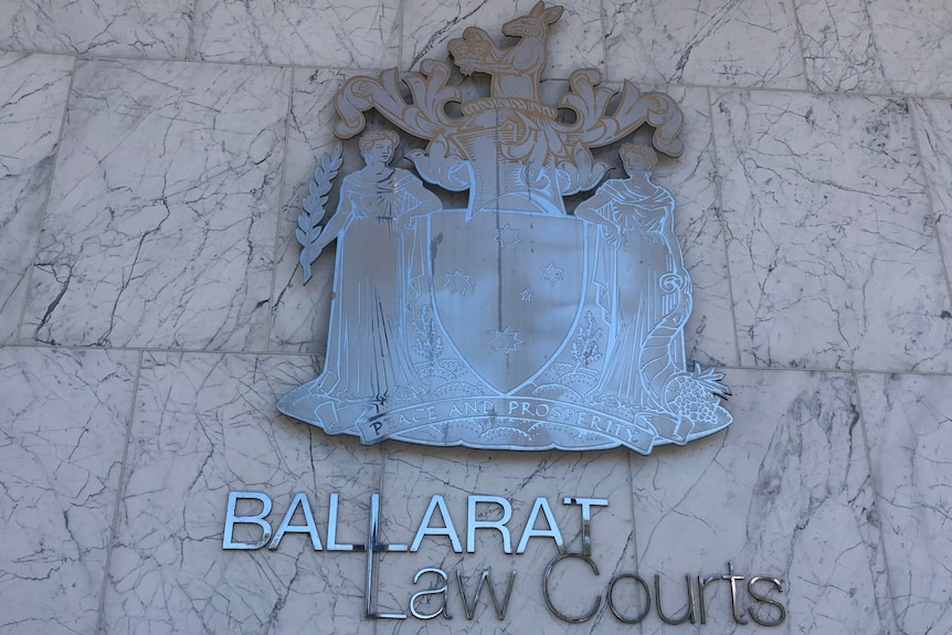 A metal sign saying Ballarat law Court beneath a symbol of the court.
