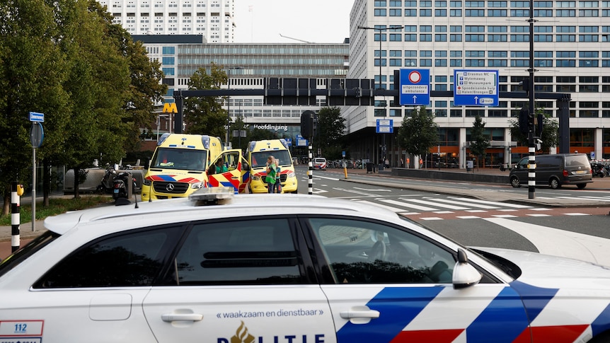 A police car is pictured in front of the medical centre in Rotterdam, behind it are two ambulances.