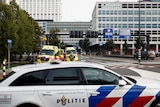 A police car is pictured in front of the medical centre in Rotterdam, behind it are two ambulances.