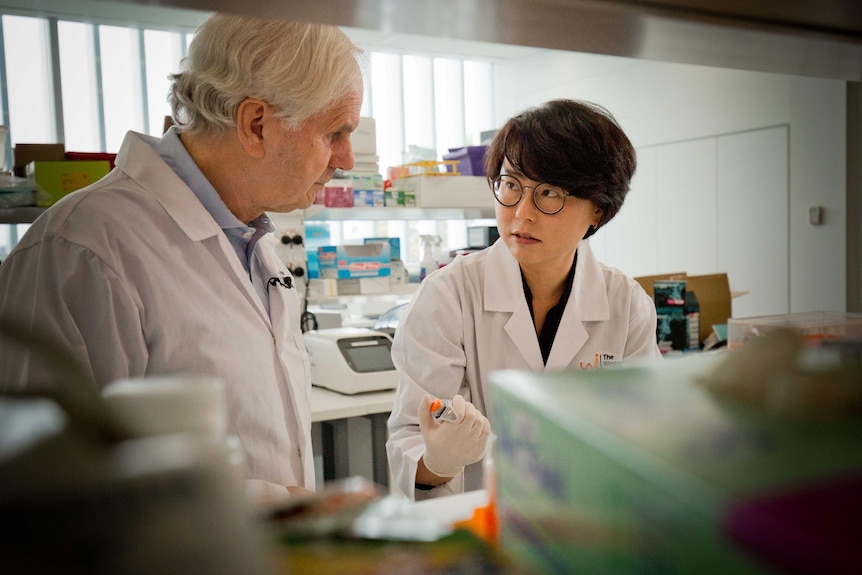 A man and a woman in a lab coat.