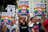 Protesters holding anti-Putin posters march past Downing Street in central London on August 10th, 2013.