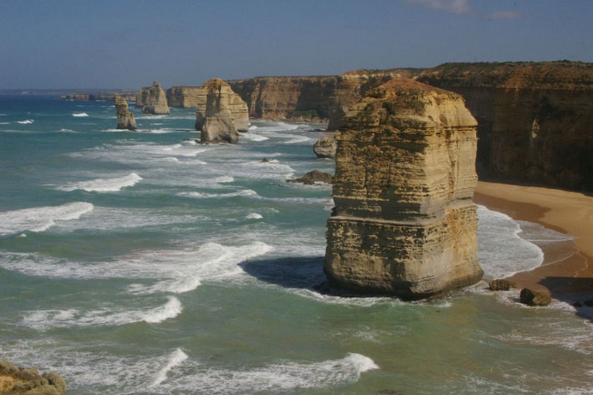 The twelve apostles, large pieces of rock jutting out from blue ocean.