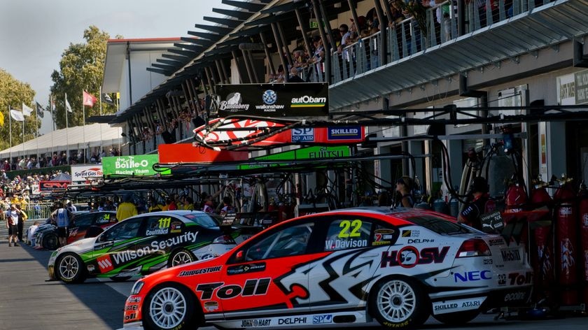 Race cars along pit lane at the inaugural V8 Supercar race meeting in Townsville.