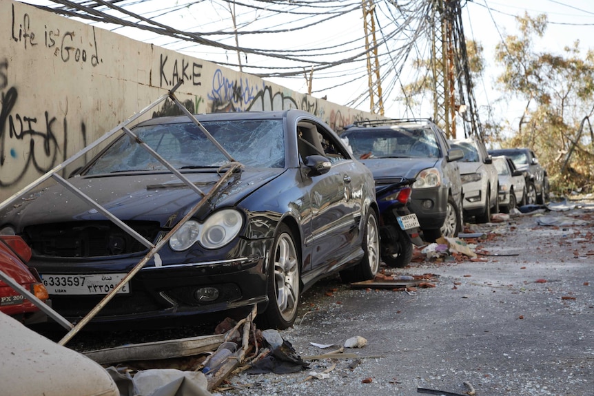 A row of cars with smashed windscreens