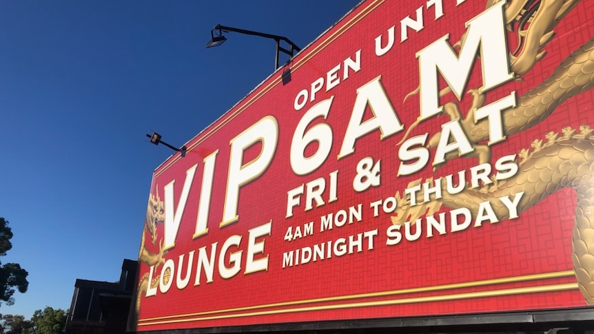 A billboard saying "VIP lounge open until 6am Friday and Saturday"