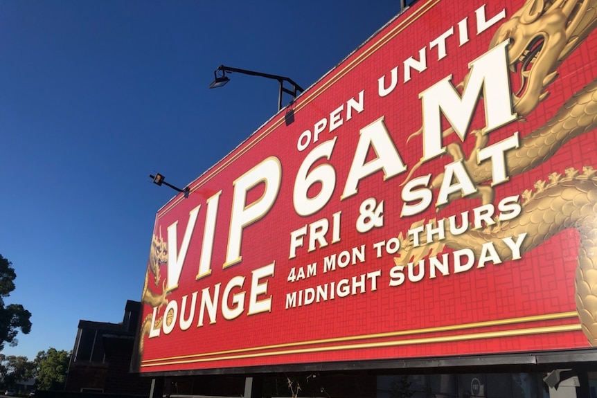 A billboard saying "VIP lounge open until 6am Friday and Saturday"