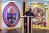 Bishop Lamor Miller-Whitehead reacts as armed men break up his church service