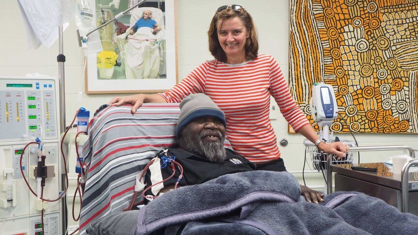 Nurse Deb Lillis stands by the bedside of dialysis patient Sam Nelson in Alice Springs.