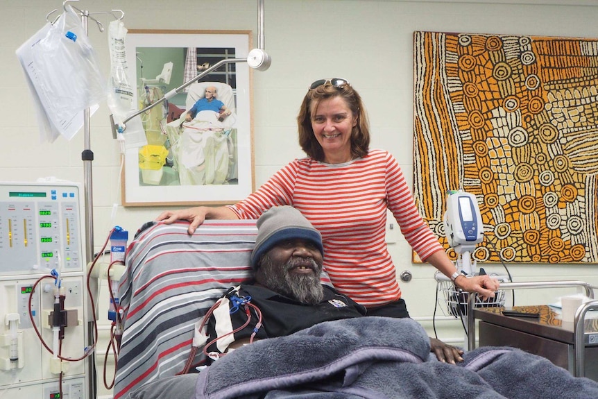 Nurse Deb Lillis stands by the bedside of dialysis patient Sam Nelson in Alice Springs.