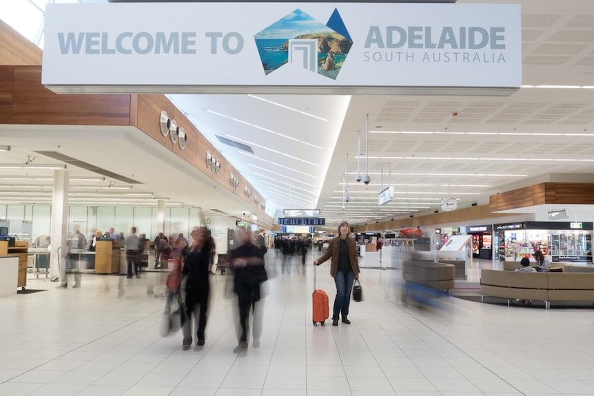 A lady checks her departure time at Adelaide Airport.