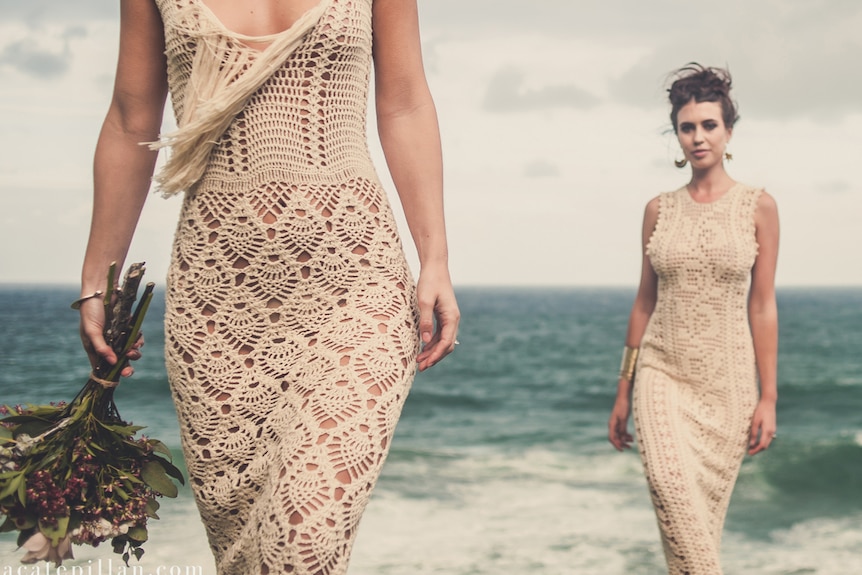 Two models in crocheted wedding gowns
