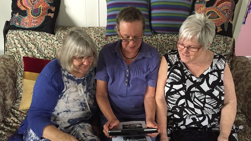 Melita Luck, Bridget Carr and Janet Wilson sitting on a couch talking to refugees on Manus Island via Facebook.