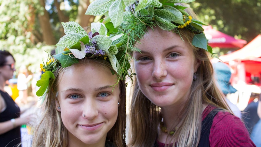 Two young girls with floral headdresses smile for the camera at Summer of Soul in South Gippsland.