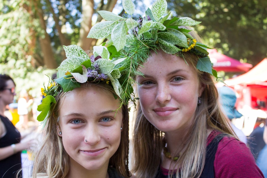 Two young girls with floral headdresses smile for the camera at Summer of Soul in South Gippsland.