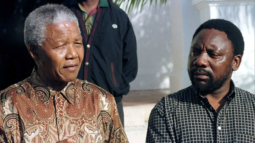 Nelson Mandela and Cyril Ramaphosa stand together at a conference