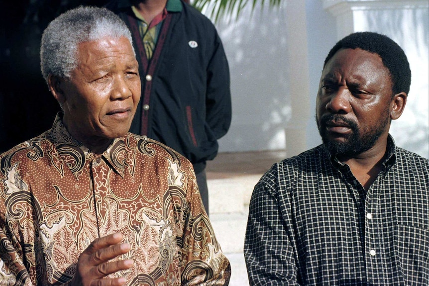 Nelson Mandela and Cyril Ramaphosa stand together at a conference